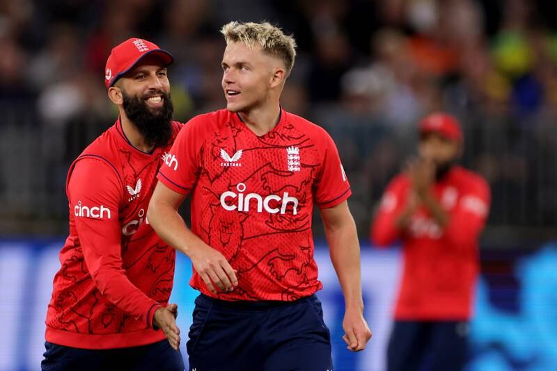 Sam Curran is congratulated by Moeen Ali after dismissing Matthew Wade during England's victory over Australia in the opening Twenty20 match at Optus Stadium in Perth on October 9, 2022. EPA