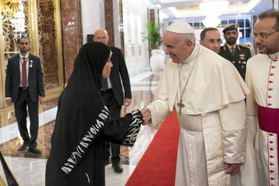 ABU DHABI, UNITED ARAB EMIRATES - February 3, 2019: Day one of the UAE Papal visit - HE Dr Amal Abdullah Al Qubaisi, Speaker of the Federal National Council (FNC) (L) greets His Holiness Pope Francis, Head of the Catholic Church (C), at the Presidential Airport. 

( Ryan Carter / Ministry of Presidential Affairs )
---