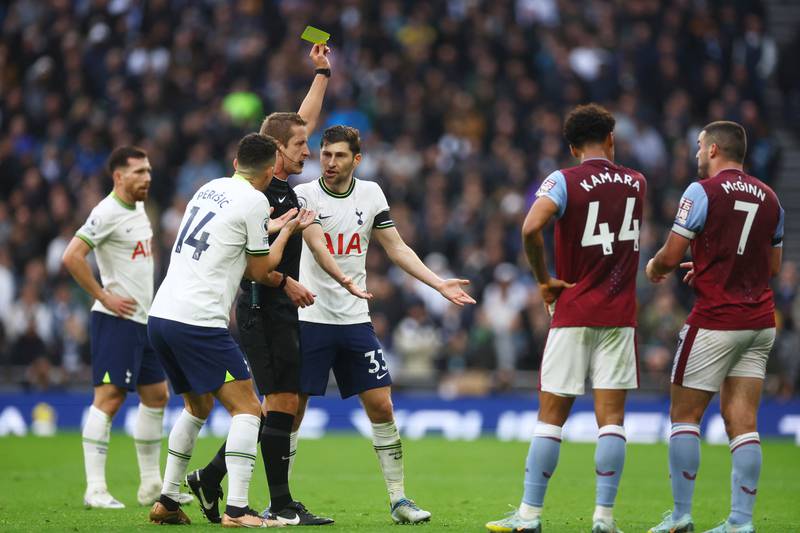 Tottenham's Ben Davies is shown a yellow card by referee John Brooks. Reuters