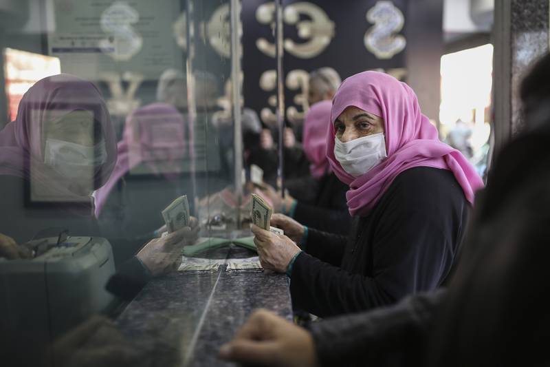 A women changes Turkish lira to dollars at a currency exchange office in Istanbul. AP