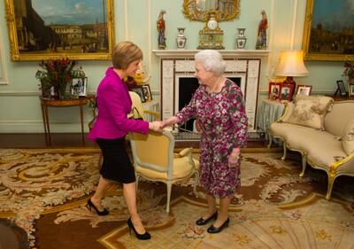 Ms Sturgeon attends her first audience with Queen Elizabeth II at Buckingham Palace in December 2014. Getty
