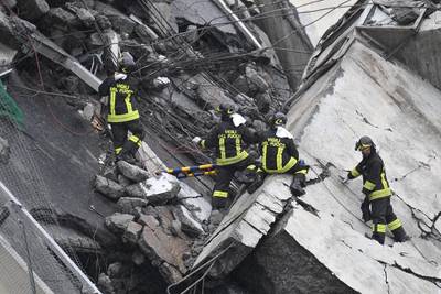 Rescuers at work amid the rubble. EPA