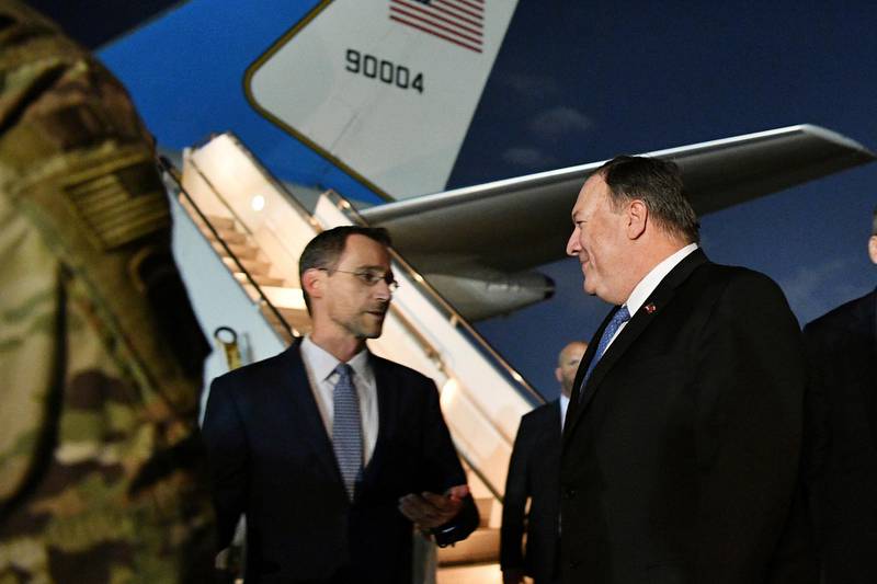 In this May 7, 2019 photo, Secretary of State Mike Pompeo, center, talks with Charge D'affaires at the US Embassy in Baghdad Joey Hood, left, after he arrived in Baghdad, for meetings. A senior officer in the U.S.-led military coalition combating the Islamic State says there is no increased threat from Iranian-backed forces in Iraq or Syria. British Maj. Gen. Chris Ghika, speaking from coalition headquarters in Baghdad, made the remark to reporters at the Pentagon in a video teleconference Tuesday. Last week, Pompeo abruptly canceled a scheduled visit to Germany to show support for the Iraqi government and underscore its need to protect Americans in the country.  (Mandel Ngan/Pool Photo via AP)