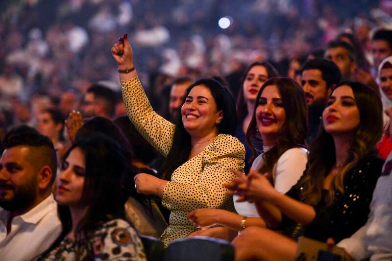 Ladies sing along to Iraqi singer, Kadim Al Sahir during the Eid concert held in Etihad Arena, Yas Island. Khushnum Bhandari / The National