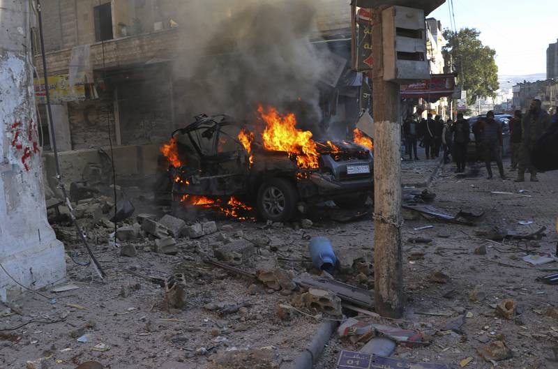 A burning car hit by a rocket attack in the town of Afrin, north of Aleppo in January. The latest incident follows attacks by Turkish drones and warplanes on the Kurdish YPG militia in Syria over the past few days. AP