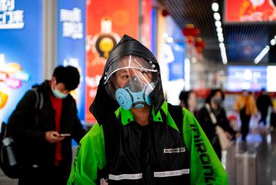 A passenger wearing a face mask upon arrival at Wenzhou railway station in Wenzhou. The National Health Commission on March 1 reported 573 new infections, bringing the total number of cases in mainland China to 79,824. AFP