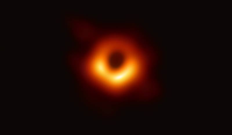 epa07496265 An undated handout photo made available by Event Horizon Telescope Collaboration on 10 April 2019 showing a bright ring formed as light bends in the intense gravity around a black hole that is 6.5 billion times more massive than the Sun. Scientists have obtained the first image of a black hole, using Event Horizon Telescope observations of the center of the galaxy M87. This long-sought image provides the strongest evidence to date for the existence of supermassive black holes and opens a new window onto the study of black holes, their event horizons, and gravity.  EPA/EVENT HORIZON TELESCOPE COLLABORATION / HANDOUT  HANDOUT EDITORIAL USE ONLY/NO SALES