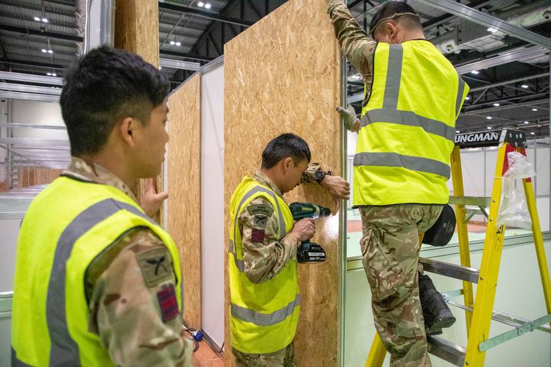 Members of the Queen's Ghurka Engineers Regiment have been enlisted for the task of turning an exhibition space into a medical facility. Courtesy EPA