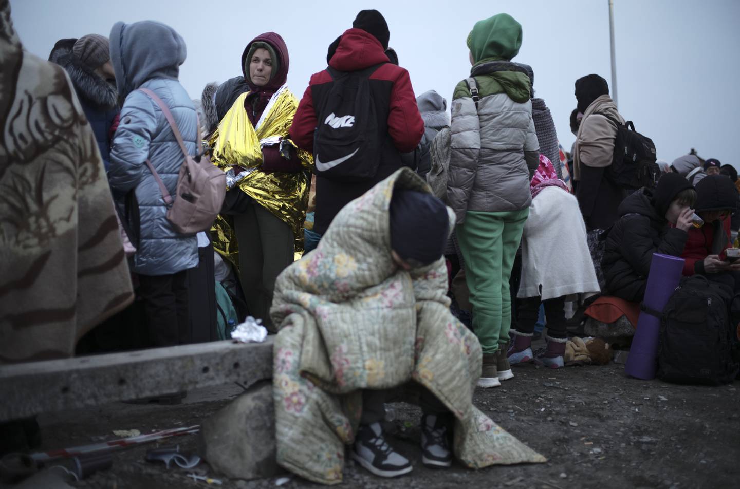 Women and children wait for transport in Medyka, Poland, after fleeing from Ukraine.  AP