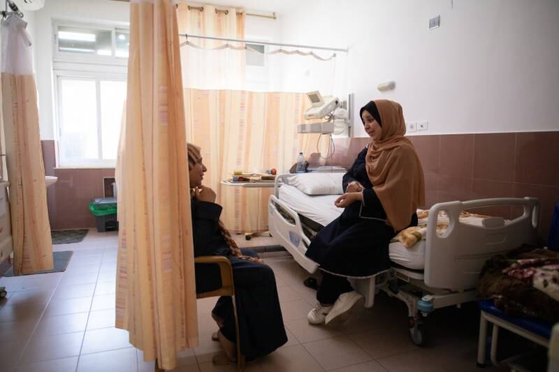 Fatma Ali, right, from Gaza, speaks with her mother in the obstetrics and gynaecology department at Al Makassed Hospital in East Jerusalem. All photos: Corinna Kern for The National