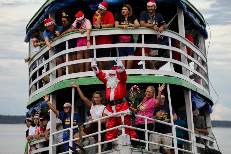 Santa Claus delivering gifts to children at the Iranduba riverside community in Manaus, Brazil. AFP