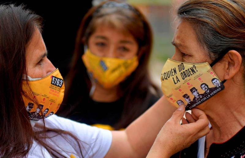 Members of the Mothers of False Positives (Mafapo) civil organization wear face masks reading “Who gave the order?” against the spread of the novel coronavirus in Soacha, Colombia. Thousands of extrajudicial executions known as "false positives" were carried out in the biggest scandal of the Colombian military forces in their struggle of more than half a century against rebel groups. The mothers of the victims found in the making of face masks a way to make their cause visible. AFP