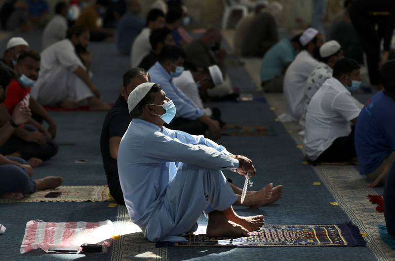 Muslim men perform noon prayers at a mosque on the first working Friday in Dubai. Photo: AFP