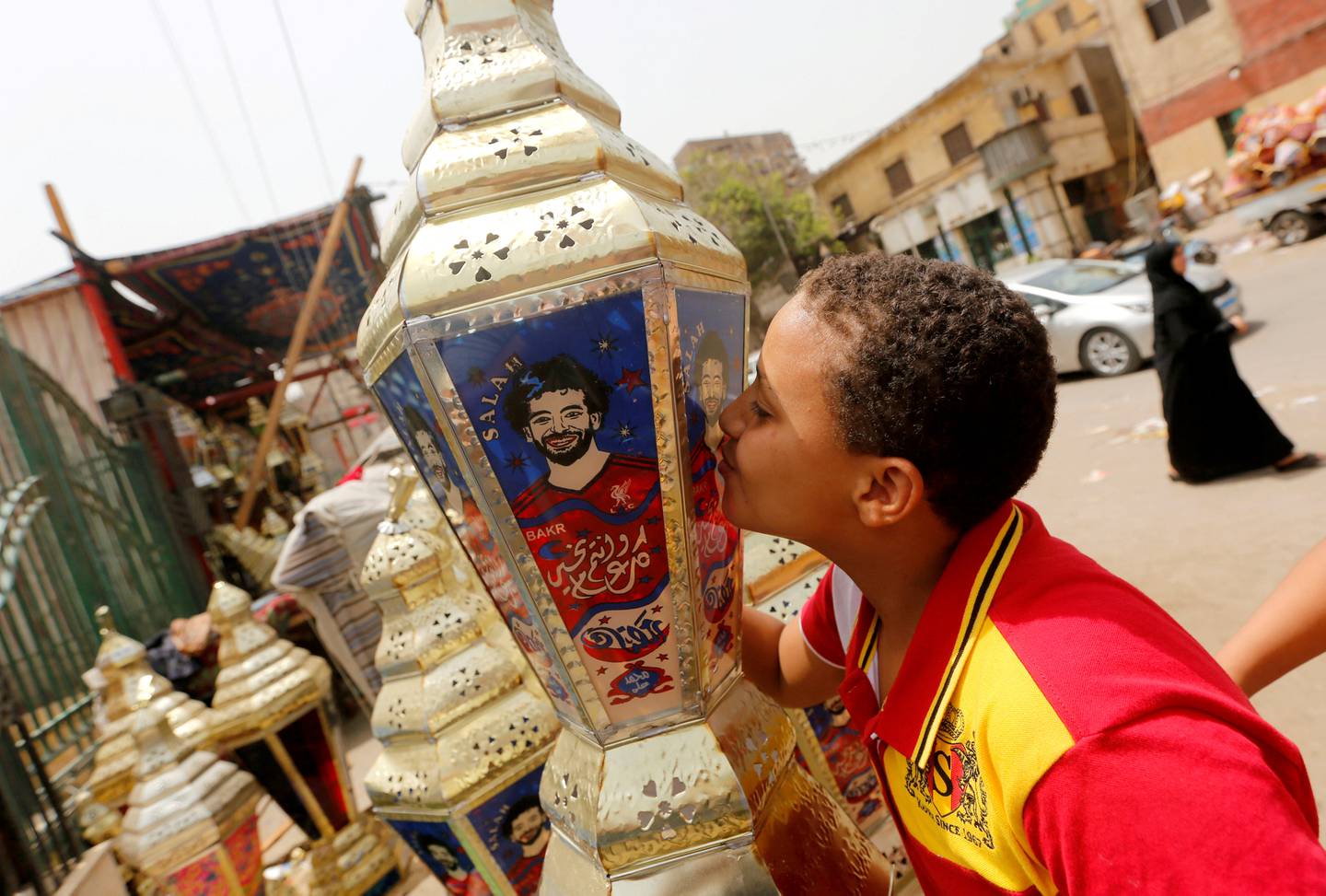 REFILE - ADDING RESTRICTIONS An Egyptian boy kisses the traditional decorative lanterns known as