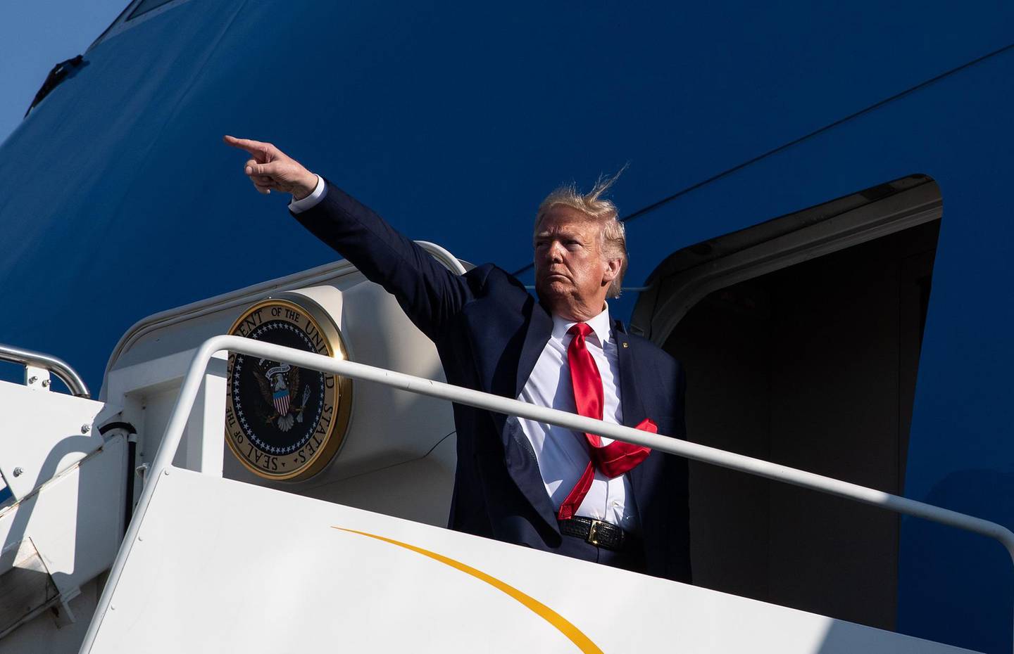 TOPSHOT - US President Donald Trump points as he boards Air Force One at Bangor International airport in Bangor, Maine, on June 5, 2020.  / AFP / NICHOLAS KAMM
