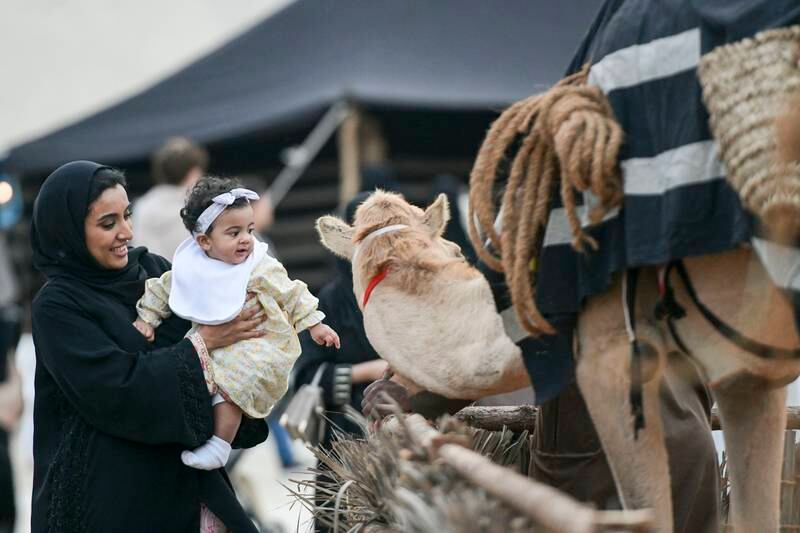 Families enjoy the camel display at Al Hosn Festival, Abu Dhabi. All photos by Khushnum Bhandari / The National
