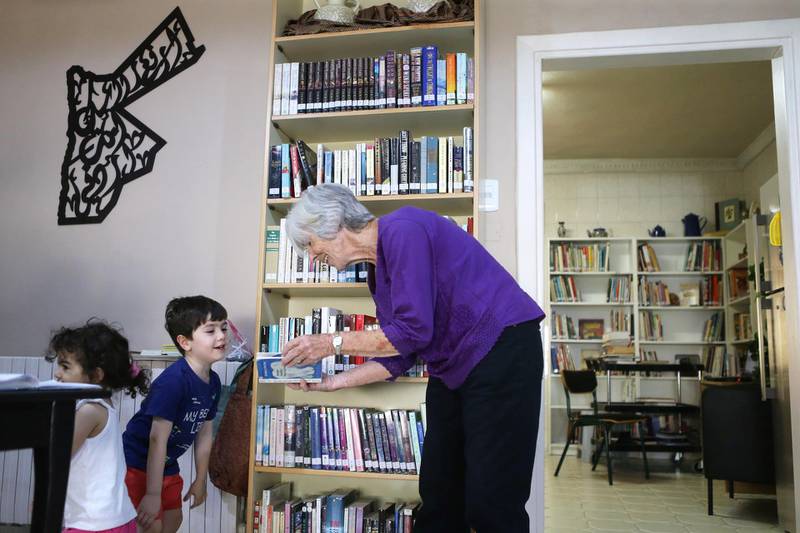 Nancy talks to children visiting her library. Nancy and Harvey, an American couple who own the library Books and More are seen in their library in Amman, Jordan. (Salah Malkawi for The National)