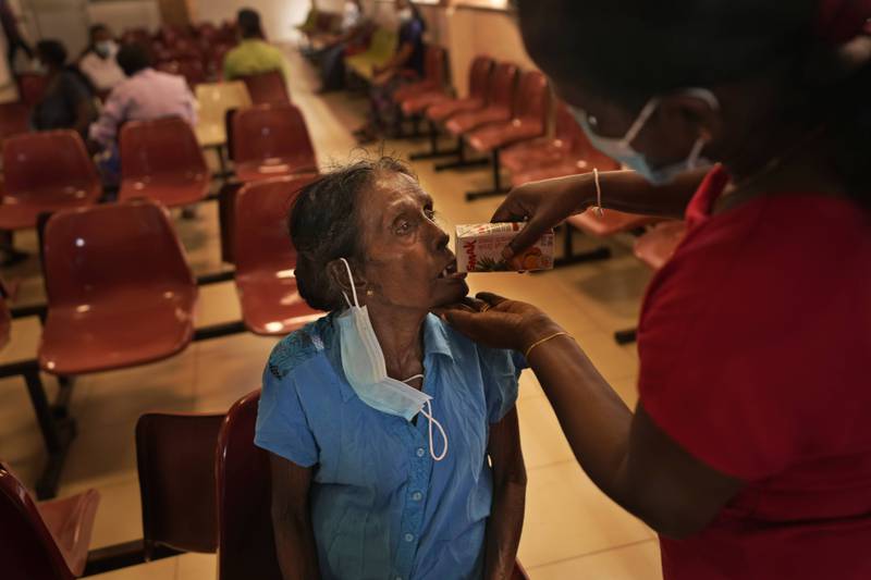 Mudiyansege Chandrawathi, a cancer patient, has a drink after attending a clinic at the national cancer hospital in Maharagama, a suburb of Colombo. AP Photo