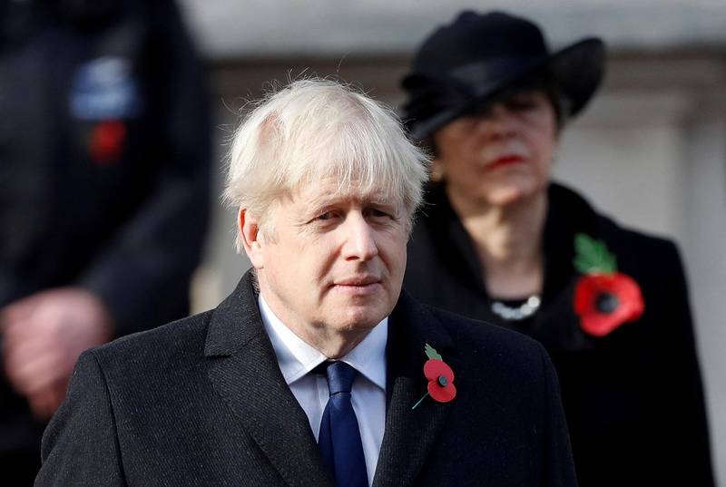 Britain's Boris Johnson attends the Remembrance Sunday service at the Cenotaph, in Whitehall, London, Sunday Nov. 8, 2020. (Peter Nicholls/Pool Photo via AP)