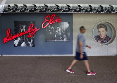 Pictures of  Elvis Presley line the wall of a gift shop. Reuters