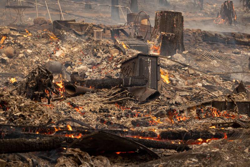 The ruins of a home gutted by the fire smoulder near Midpines, north-east of Mariposa county. AFP