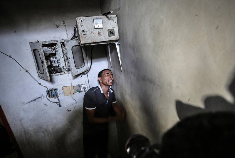 A relative of 23-year-old Ahmad Al-Qarra mourns during his funeral in Khan Younis, southern Gaza Strip. EPA