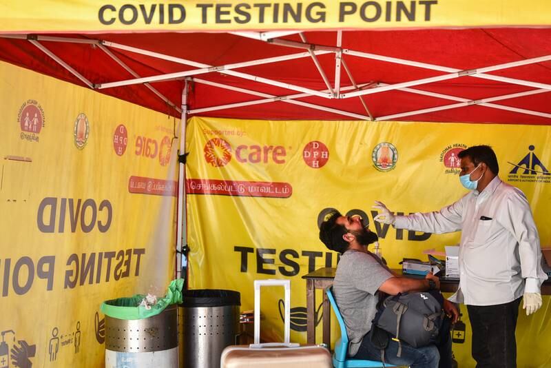 Under tightened Covid-19 rules, a passenger is tested for the coronavirus after arriving at Chennai International Airport, in eastern India. EPA