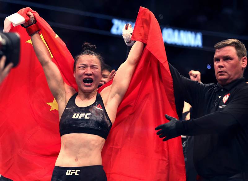 Zhang Weili celebrates her win by decision over Joanna Jedrzejczyk in the women's strawweight championship mixed martial arts bout at UFC 248 on Saturday, March 7, 2020, in Las Vegas. (L.E. Baskow/Las Vegas Review-Journal via AP)