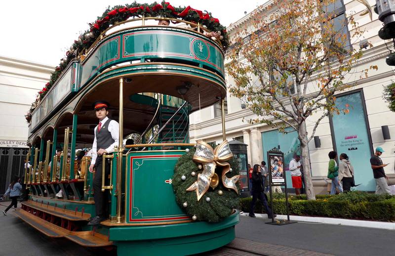 A tram is adorned with holiday decorations three days before Christmas in Los Angeles, California. AFP