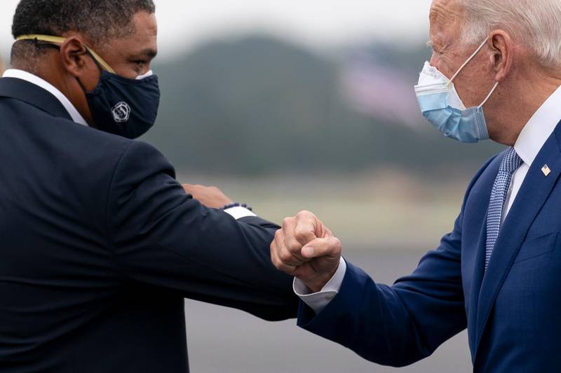 Democratic presidential candidate former Vice President Joe Biden greets Rep. Cedric Richmond, D-La., left, as he arrives at Columbus Airport in Columbus, Ga.  AP