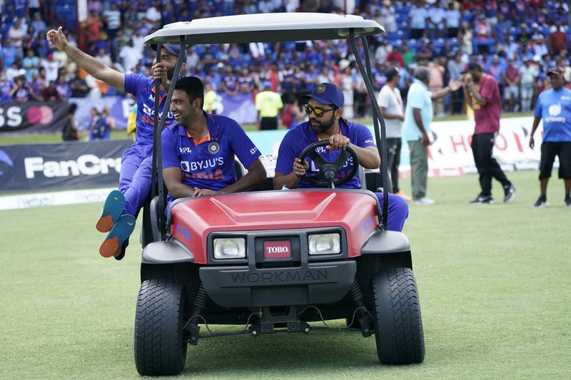 India's Dinesh Karthik, left, Ravichandran Ashwin, centre, and Rohit Sharma ride in a cart after the fifth T20. AP