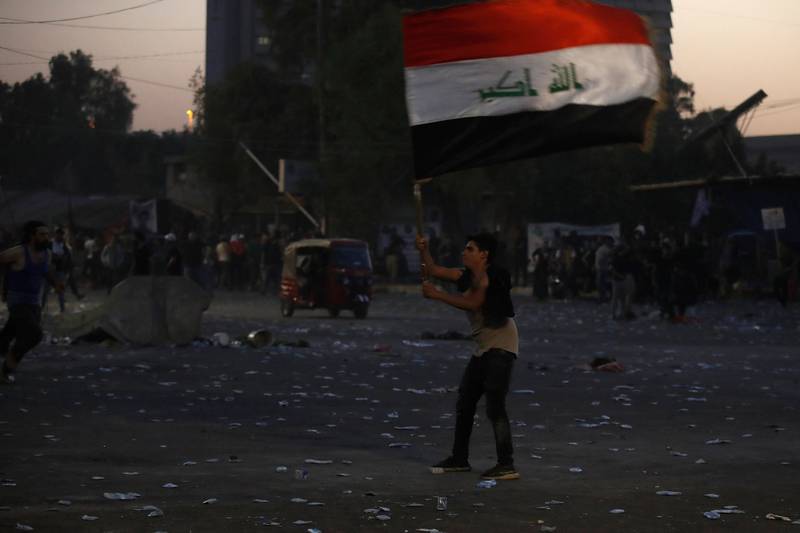 An Al Sadr supporter waves the Iraqi flag in Baghdad after the powerful Shiite cleric announced his retirement from politics. AFP