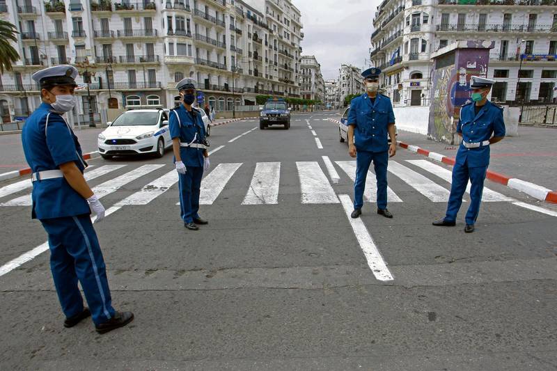 Algerian police officers block the access in central Algiers. Algeria's government announced earlier this week it is reinforcing curfew restrictions imposed nationwide to limit the spread of the coronavirus. AP Photo