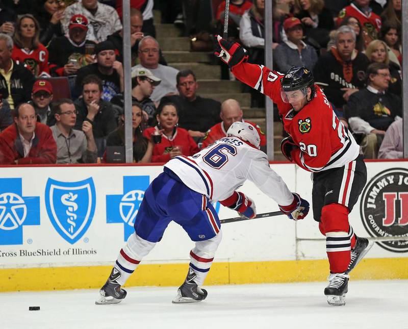 Brandon Saad, right, of the Chicago Blackhawks skates around Josh Gorges of the Montreal Canadiens at the United Center on April 9, 2014, in Chicago, Illinois. Jonathan Daniel / Getty Images