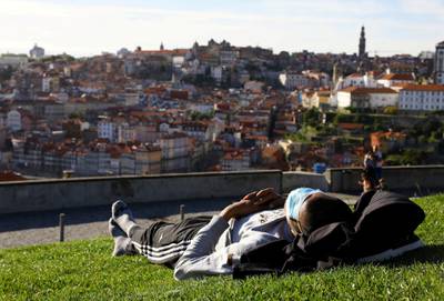 A man enjoys the sunny weather on the first day that tourists from Britain and most EU countries are allowed to enter Portugal without needing to quarantine, in Vila Nova de Gaia, Portugal. Reuters