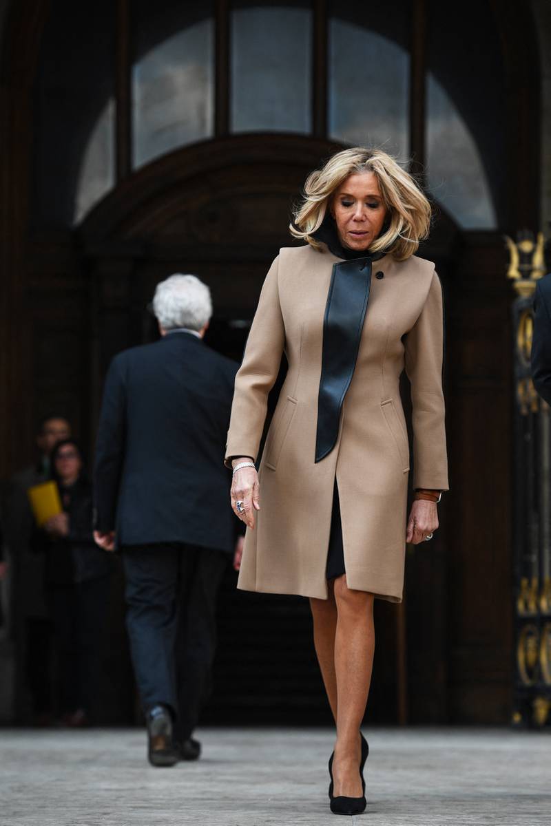 Brigitte, wearing a camel Louis Vuitton coat with black leather detail, at the Palais Garnier opera house in Paris on March 25, 2019. AFP