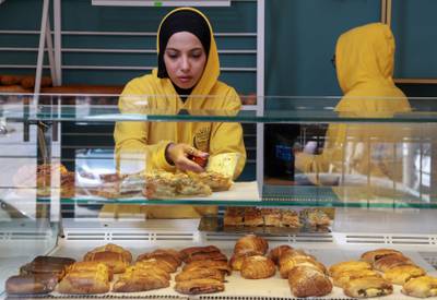 A staff member arranges baked goods at the bakery, which is  not subsidised by the Tunisian state.