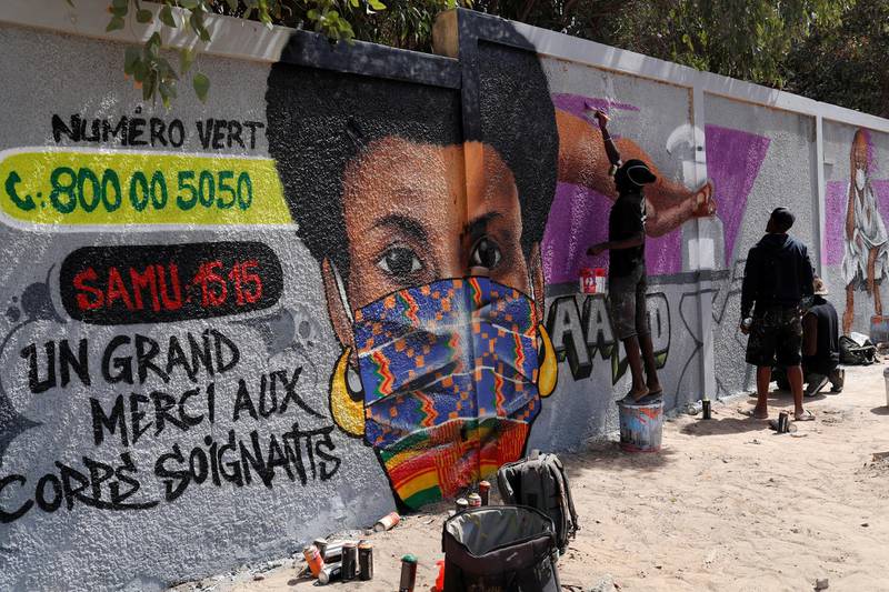 Graffiti artists from RBS crew work on their mural to encourage people to protect themselves amid the outbreak of the coronavirus disease in Dakar, Senegal. Reuters