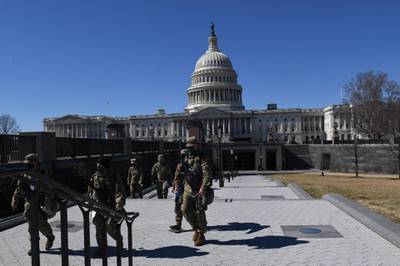 Members of the National Guard walk near the US Capitol Building on Capitol Hill March 3, 2021, in Washington, DC. Police said March 3, 2021 they have bolstered security in Washington after intelligence uncovered a "possible plot to breach the Capitol" on March 4, a day that holds significance for conspiracy-believing supporters of former president Donald Trump. "We have obtained intelligence that shows a possible plot to breach the Capitol by an identified militia group on Thursday, March 4," the US Capitol Police said in a statement on Twitter, nearly two months after a deadly riot by Trump supporters shook the citadel of American democracy. / AFP / Eric BARADAT
