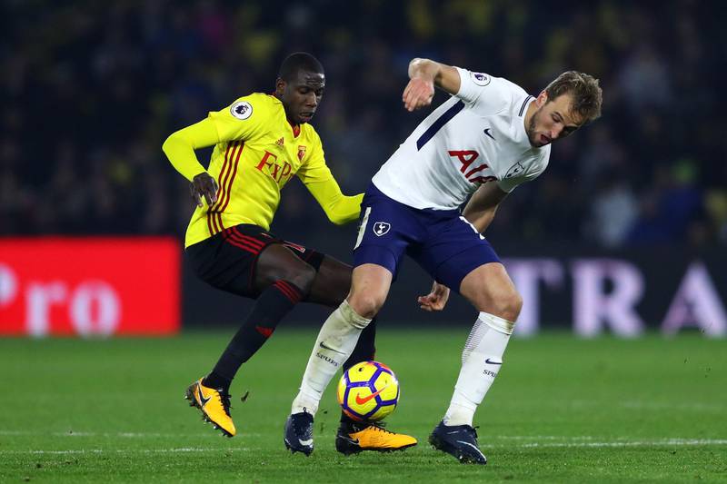 WATFORD, ENGLAND - DECEMBER 02: Harry Kane of Tottenham Hotspur is challenged by Abdoulaye Doucoure of Watford during the Premier League match between Watford and Tottenham Hotspur at Vicarage Road on December 2, 2017 in Watford, England.  (Photo by Warren Little/Getty Images)