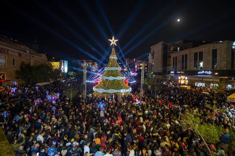 Crowds gather around a giant Christmas tree that has been officially lit up at the entrance of Byblos, in Lebanon, on Thursday. EPA