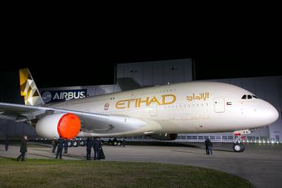 The first Etihad Airways PJSC Airbus A380-800 aircraft is rolled out during an event to mark its unveiling at the Airbus Group NV paint plant in Hamburg, Germany, on Thursday, Sept. 25, 2014. Etihad unveiled a new livery design that will be introduced across its fleet as it officially rolled out its first Airbus A380 aircraft in Hamburg yesterday. Photographer Krisztian Bocsi/Bloomberg