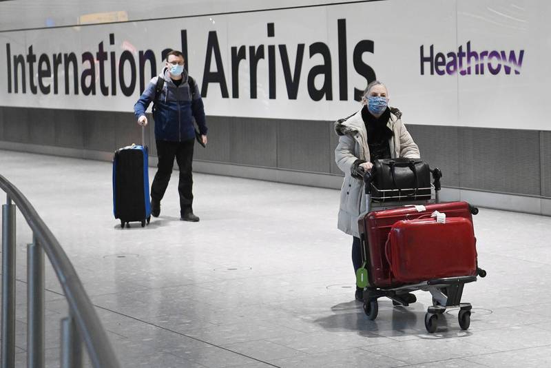 epa08938743 Travelers carry luggage in the international arrival area of Heathrow Airport near London, Britain, 15 January 2021. Travelers from South America are no longer allowed to come into the UK, amid fears over a new coronavirus variant first identified in Brazil. The UK travel ban also applies to Portugal and Cape Verde came into force at 04:00 GMT on 15 January 2021.  EPA/NEIL HALL