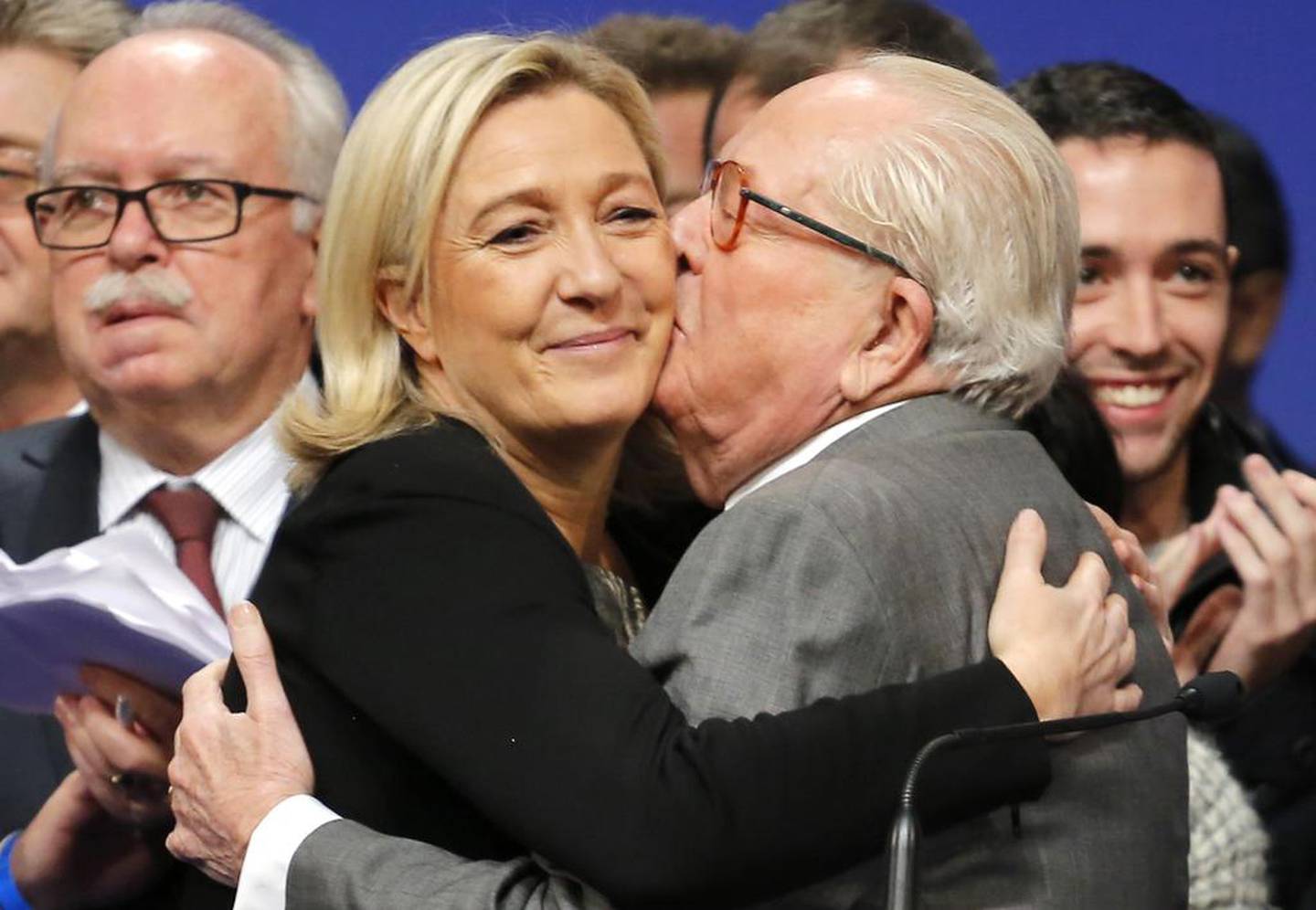 French far-right National Front leader Marine Le Pen is kissed by her father Jean-Marie Le Pen after being re-elected as president of the party in 2014. AP