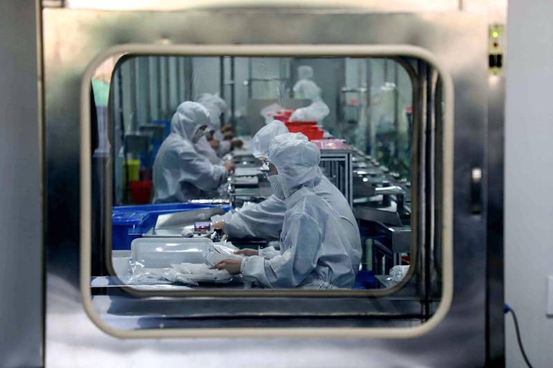 Workers produce medical supplies at a factory in Binzhou in China's eastern Shandong province. AFP
