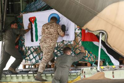 Workers at Marka military airport in Amman, Jordan, load a military plane with humanitarian aid for Libya. AFP