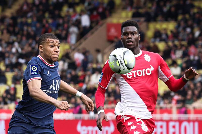 Paris Saint-Germain's Kylian Mbappe fights for the ball with Monaco's Benoit Badiashile. AFP