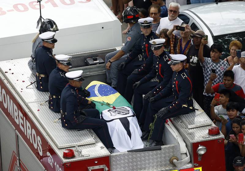 The casket of Brazilian legend Pele is taken through the streets of Santos during his funeral ceremony on Tuesday. Reuters