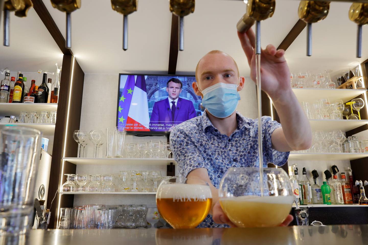 A barman pours beer in a pub in France. Reuters
