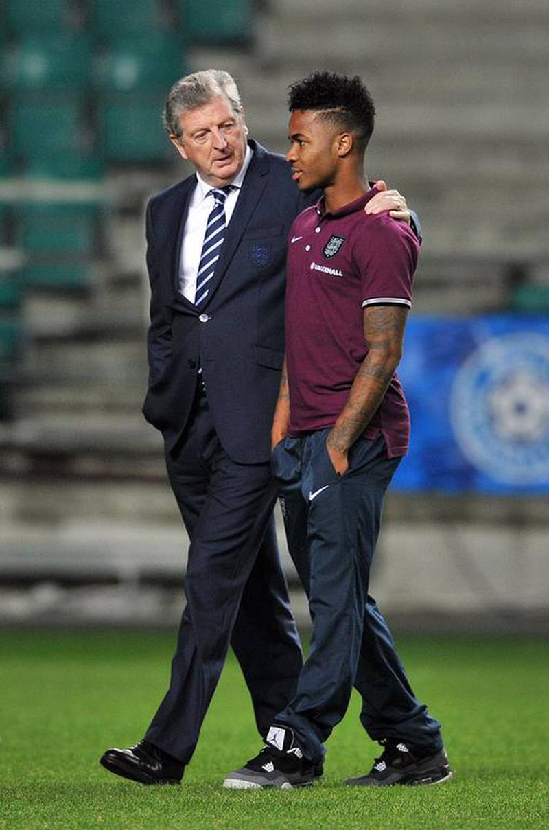 Roy Hodgson, left, seems to be building the England team around Raheem Sterling. Glyn Kirk / AFP
